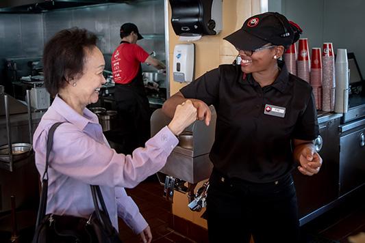 Peggy Cherng with a Panda Express employee.