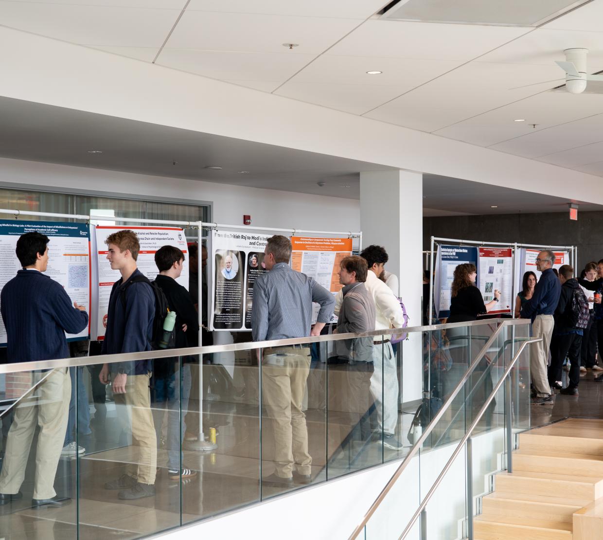 Students wander around looking at thesis posters.