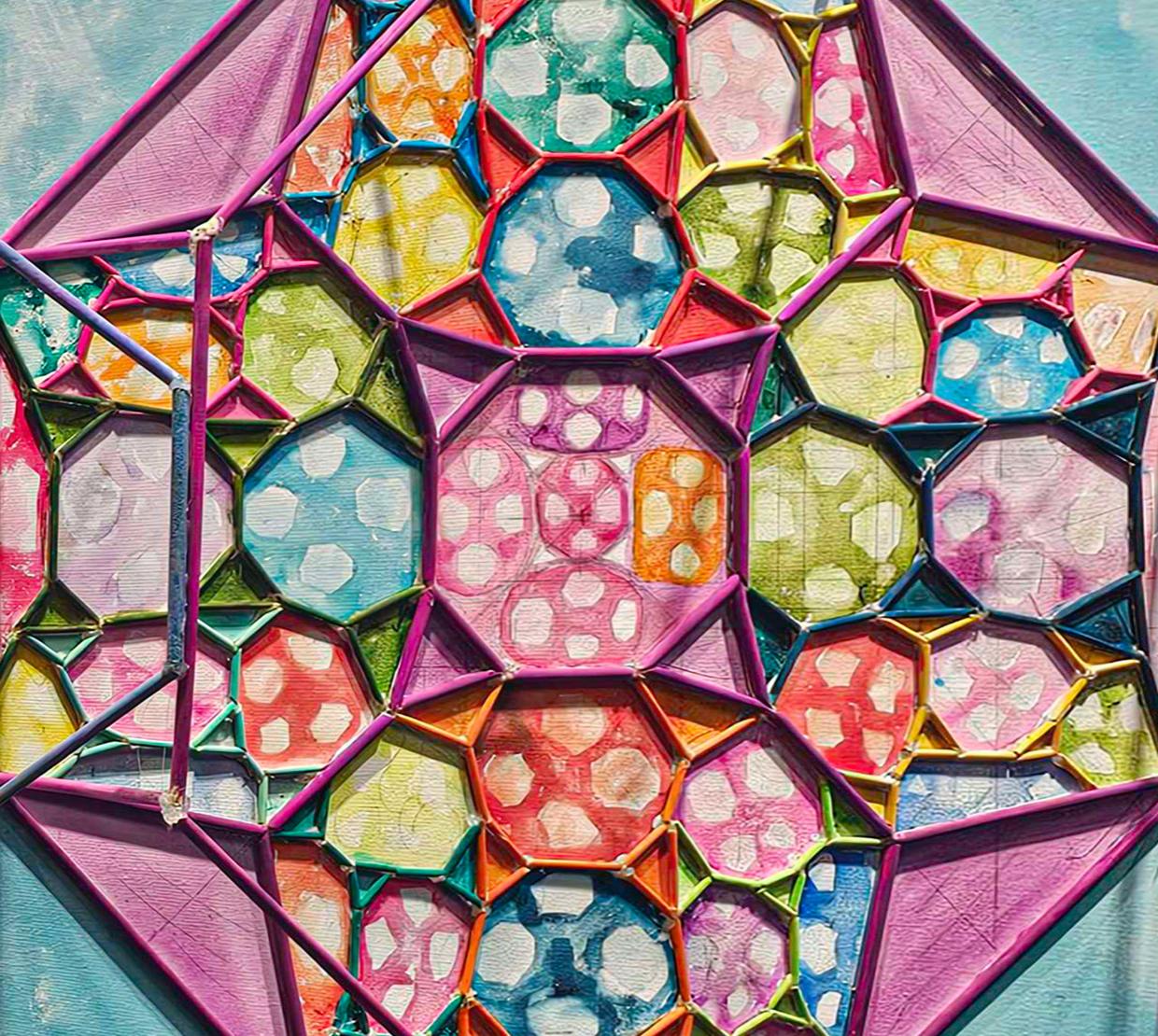 A close detail of Hubbard's artwork shows hyperbolic space rendered in brightly colored octagons using paint, wood and watercolor