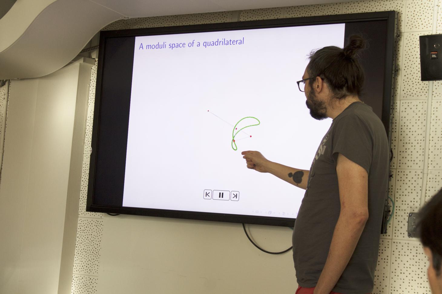 Stephen Krughoff presenting in front of a screen.