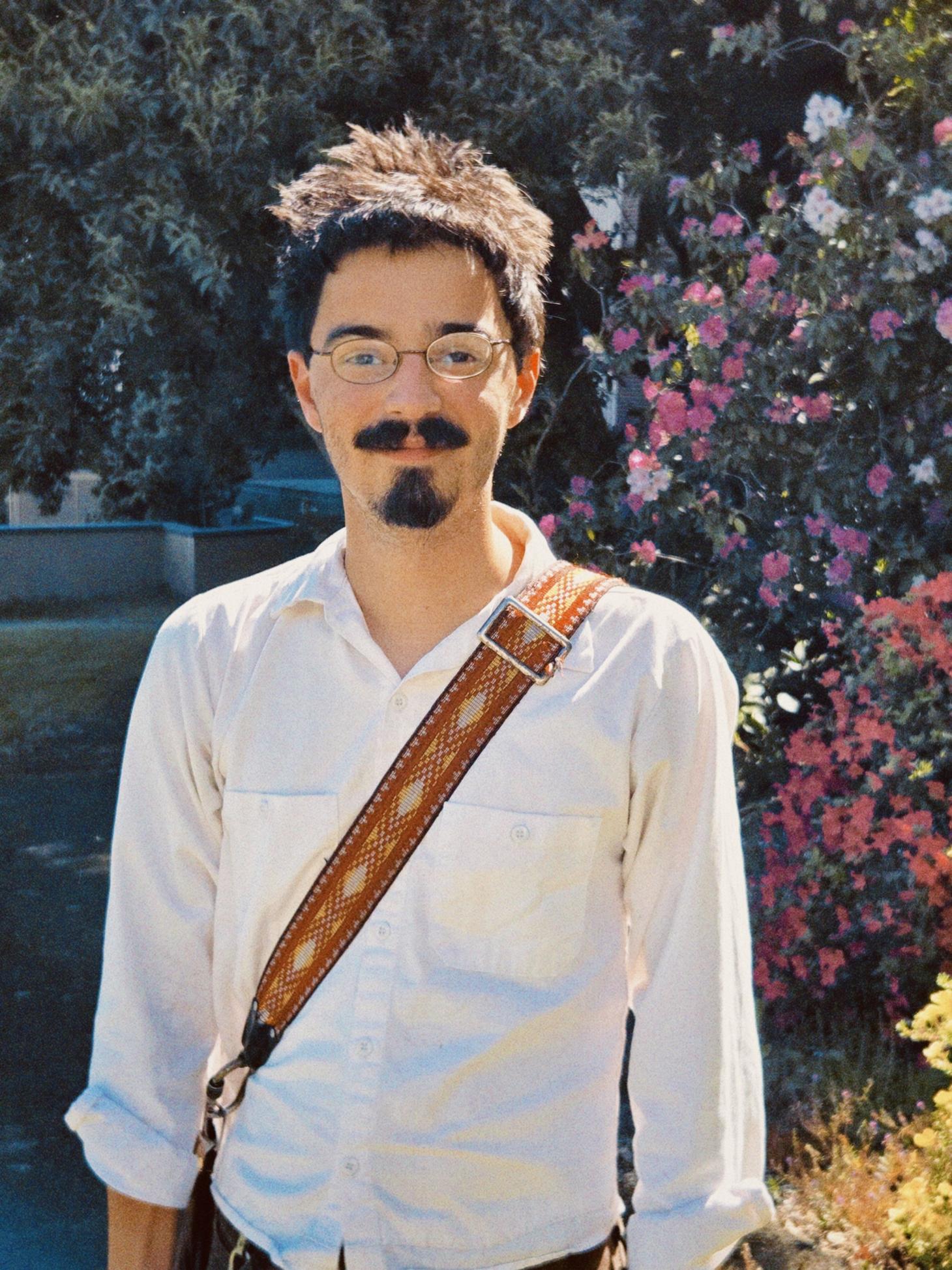 Logan Richard outside on campus with a messenger bag