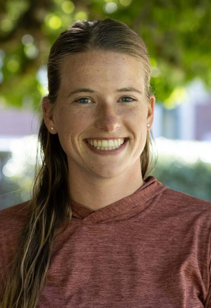 A woman in a brown shirt.